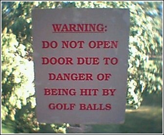 1992 Ford Bronco - Warning sign about golf ball danger posted on a door, with Supermotors.net logo.