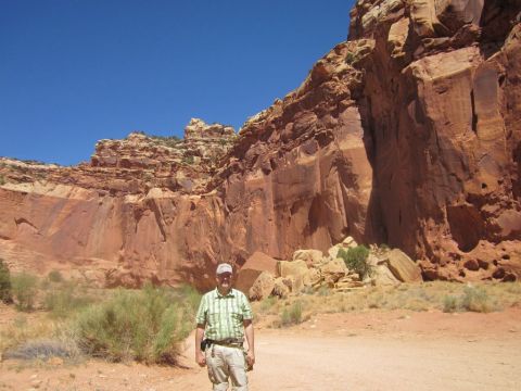 1991 Ford LTD Crown Victoria - A man poses for a photo in a desert landscape with towering red rock formations in the background.