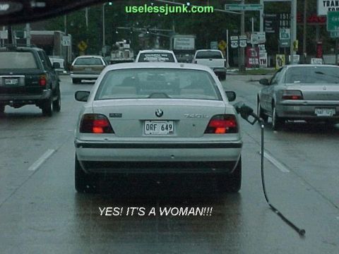 1992 Ford Bronco - A BMW 7 Series sedan is seen at a gas station with the fuel pump engaged.