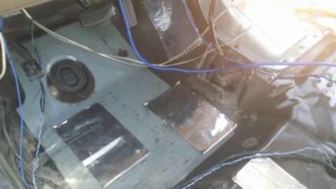1994 Ford Bronco - Soundproofing material and wiring are visible on the interior floor of a vehicle.