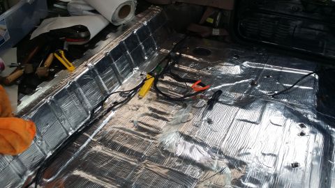 1994 Ford Bronco - Soundproofing being installed on the interior floor of a vehicle.