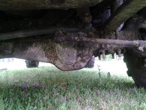 1983 Ford F-250 - Close-up view of the undercarriage, focusing on the differential and suspension components of a truck.
