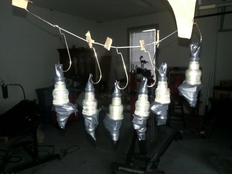 1994 Ford Bronco - Several spark plugs are suspended by wires and clothespins, ready for a coating.
