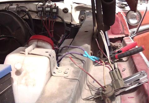 1978 Ford Bronco - This image shows the engine bay of a vehicle with various electrical components and wiring exposed for maintenance or repair.