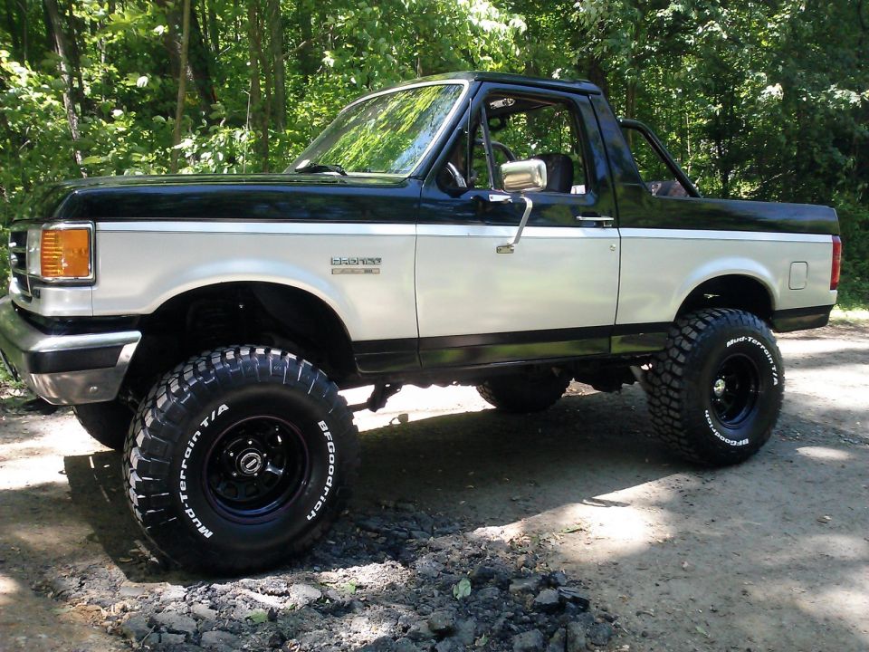 1991 Ford Bronco with BFGoodrich Mud-Terrain T/A tires parked on a dirt road