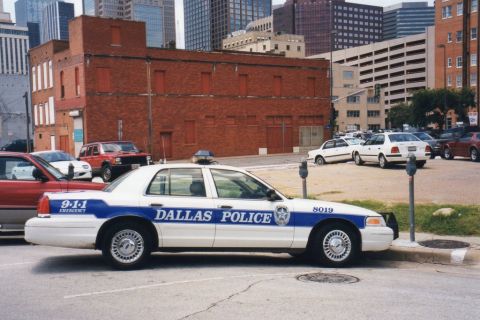 1991 Ford LTD Crown Victoria - Dallas Police Crown Victoria, marked with '9-1-1 EMERGENCY' and 'DALLAS POLICE'.