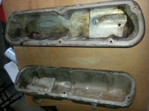 1994 Ford Bronco - Two used valve covers are shown, one placed on top of the other.