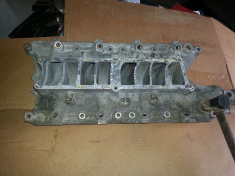 1994 Ford Bronco - This is a metal engine intake manifold with eight intake ports visible.