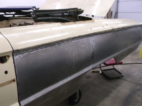 1964 Ford Galaxie - The side panel of a 1964 Ford Galaxie is shown undergoing repair, with visible welding marks.