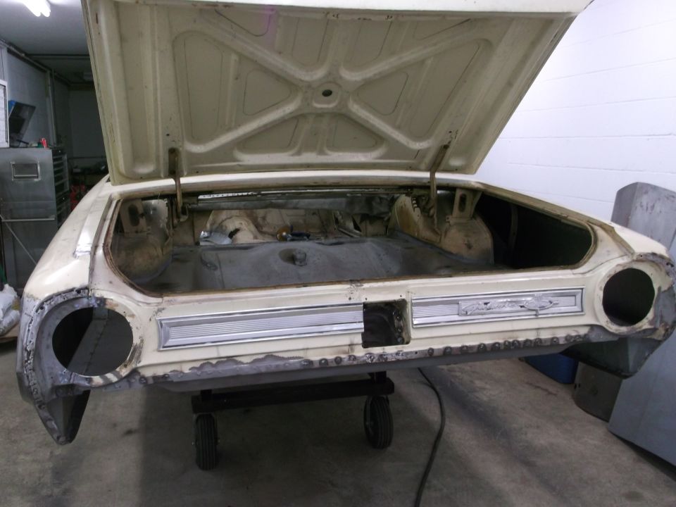 Rear of a 1964 Ford Galaxie with trunk open, showing exposed metal and some rust