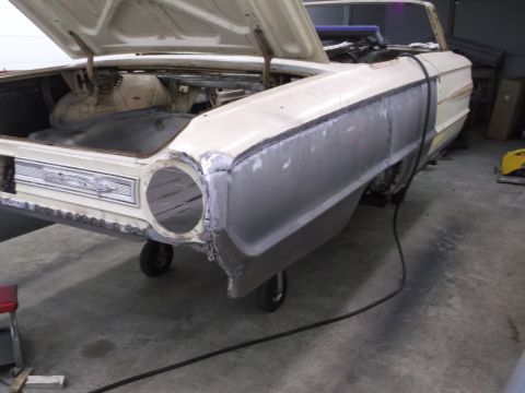 1964 Ford Galaxie - A 1964 Ford Galaxie is undergoing bodywork, with a primer gray fender and open trunk visible.