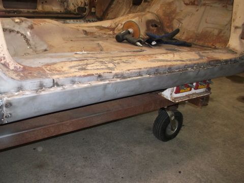 1964 Ford Galaxie - Repair work on a car's floor pan, showing new metal being welded and tools ready for use.