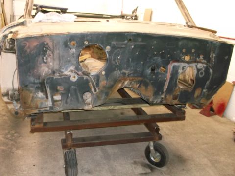 1964 Ford Galaxie - Firewall assembly of a car, mounted on a wheeled dolly for transport.