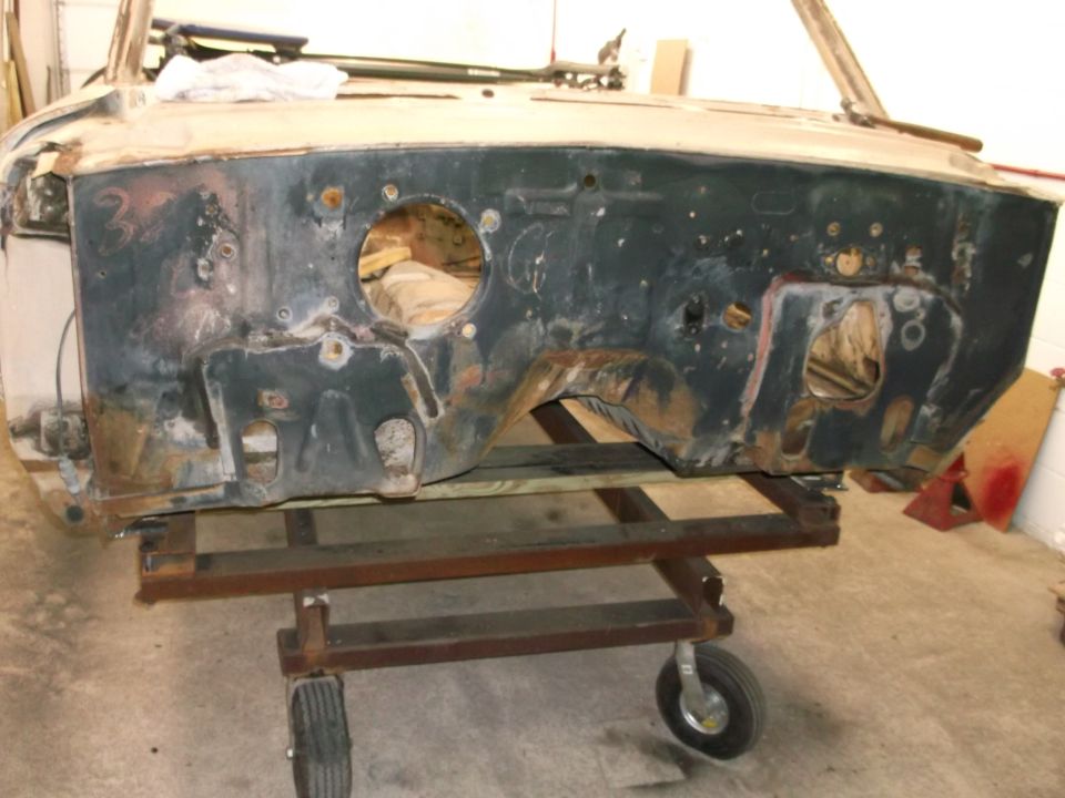 Car firewall assembly on a metal dolly with wheels