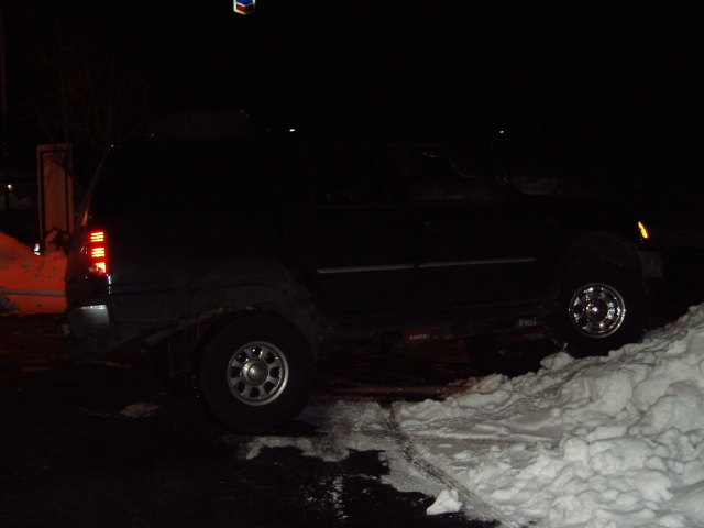 1998 Ford Expedition parked on a snowy surface at night, side view