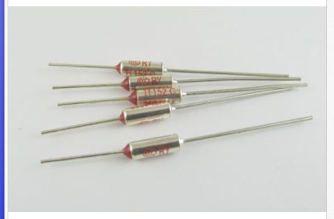 1983 Volkswagen Rabbit - A group of thermal fuses, each marked with model numbers and ratings, are laid out on a plain background.
