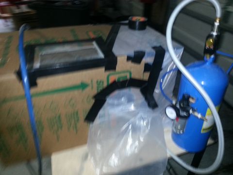 1994 Ford Bronco - Air compressor tank and associated parts are visible in this workshop setting.