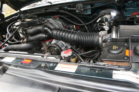 1994 Ford Bronco - Engine bay of a 1994 Ford Bronco, showing the V8 engine and associated components.