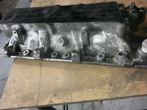 1994 Ford Bronco - Close-up of an engine block, showing its metallic texture and bolt hole patterns.