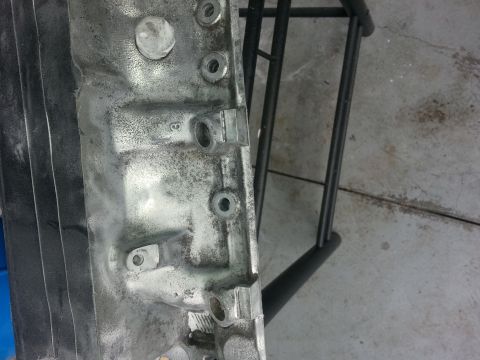 1994 Ford Bronco - Close-up of an engine block, showing its metallic texture and mounting points.