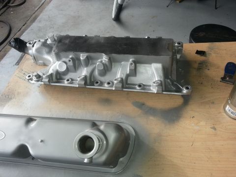 1994 Ford Bronco - Engine intake manifold and valve cover, likely undergoing restoration or preparation for installation.