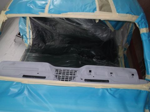1967 Ford Mustang - A dashboard component, likely for a classic car, is prepped and masked for painting.