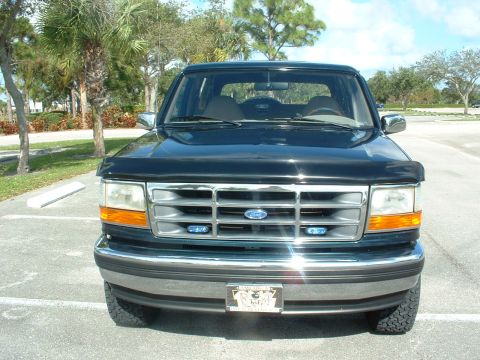 1994 Ford Bronco - Front view of a black 1994 Ford Bronco parked in a lot.