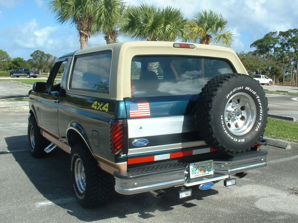 1994 Ford Bronco rear view, dark green and tan with spare tire