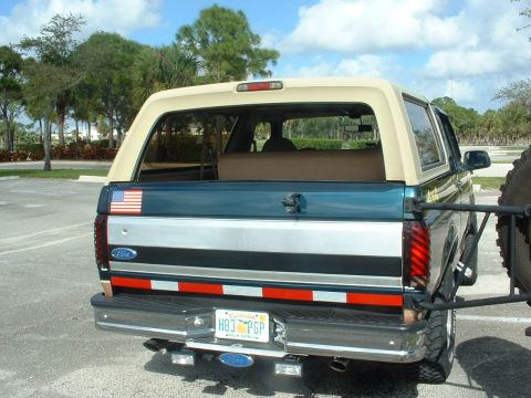 1994 Ford Bronco - This Ford Bronco features a two-tone paint scheme and a rear-mounted spare tire.