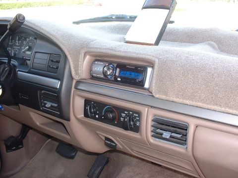1994 Ford Bronco - Interior view of a 1994 Ford Bronco, a tan dashboard, aftermarket Pioneer stereo, and climate controls.