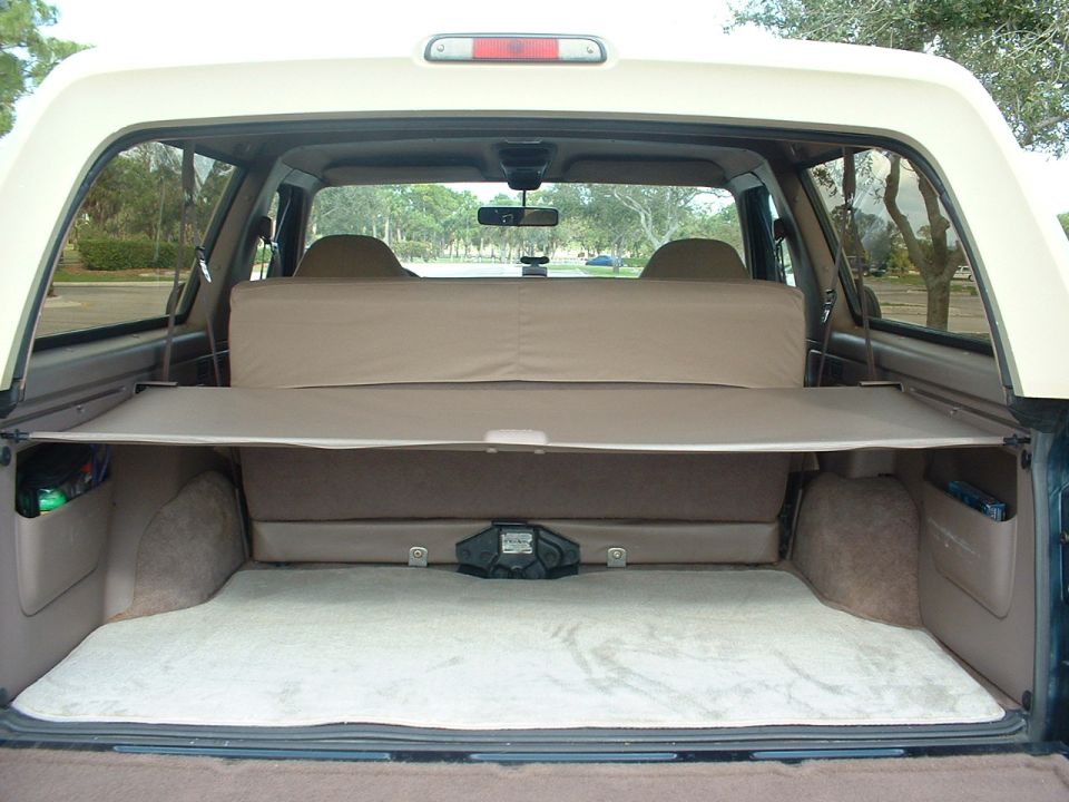 1994 Ford Bronco interior cargo area with seats folded and cargo cover extended