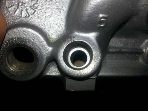 1994 Ford Bronco - A close-up view of a metal engine component, showing machined surfaces and a cast number '5'.