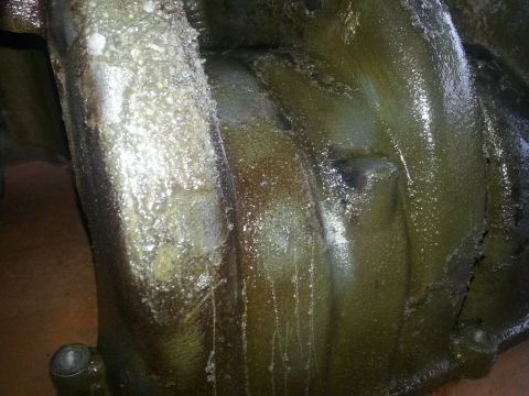 1994 Ford Bronco - Close-up of a heavily soiled engine part, showing accumulated grime and oil residue.