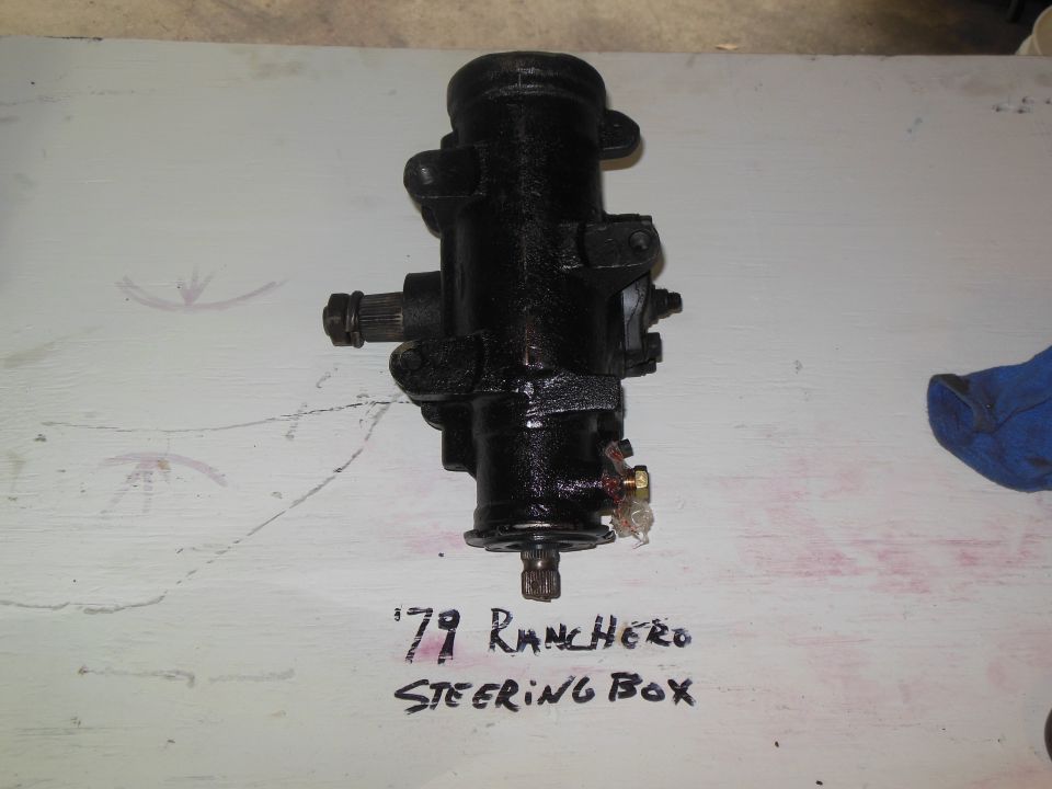 Black steering box with handwritten label '79 RANCHERO STEERING BOX'