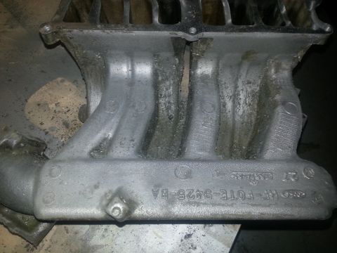 1994 Ford Bronco - Close-up of a Ford intake manifold, showing the part number RF-FOTE-9425-BA.