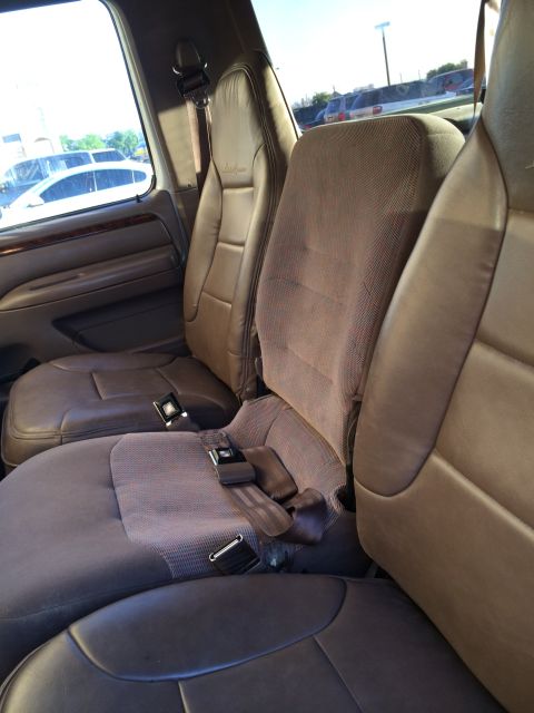 1996 Ford Bronco - Interior view of a 1996 Ford Bronco, showing the front seats and seatbelts.