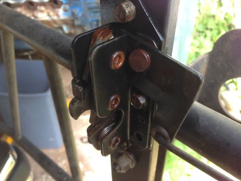 1990 Ford Bronco - This close-up shows a worn and rusty gate latch mechanism, indicating it is not a vehicle part.