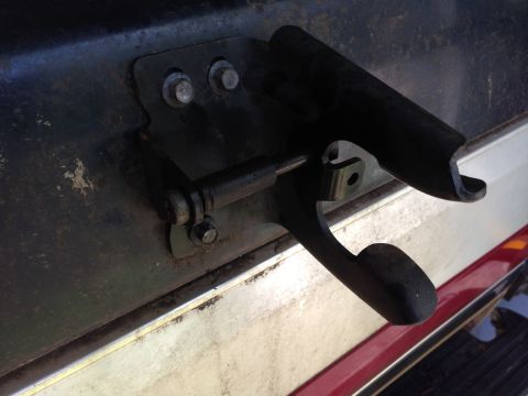 1990 Ford Bronco - Close-up of a tailgate latch mechanism, showing its mechanical components.