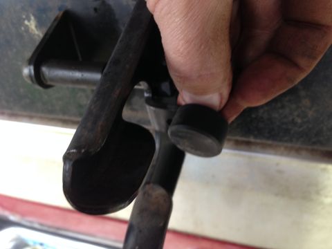 1990 Ford Bronco - A hand is shown engaging a brake lever, part of a vehicle's braking system.