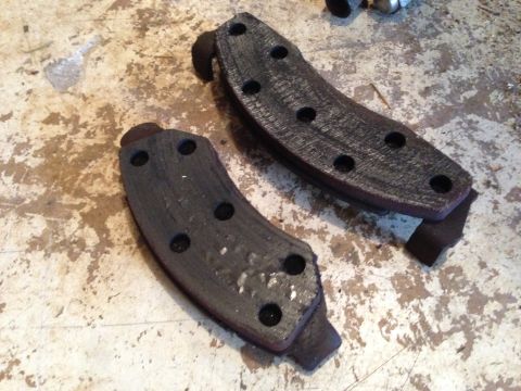 1990 Ford Bronco - A pair of used brake pads are shown, indicating a need for replacement.