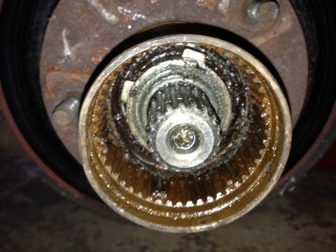 1990 Ford Bronco - Greasy wheel hub assembly part with visible splines.