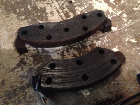 1990 Ford Bronco - These brake pads appear to be used and worn, with visible scoring on the friction material.