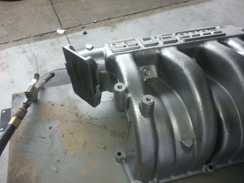 1994 Ford Bronco - A close-up view of a Ford intake manifold, possibly undergoing maintenance or cleaning.