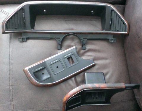 1988 Ford Bronco - Original dash trim panels. My Bronco's interior is all black and gray, so it's time for the brown "wood" to go.