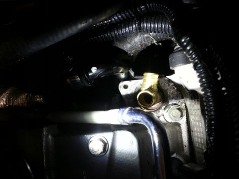 2004 Mercury Grand Marquis - Engine part with brass fitting and metal tubing visible in engine bay.