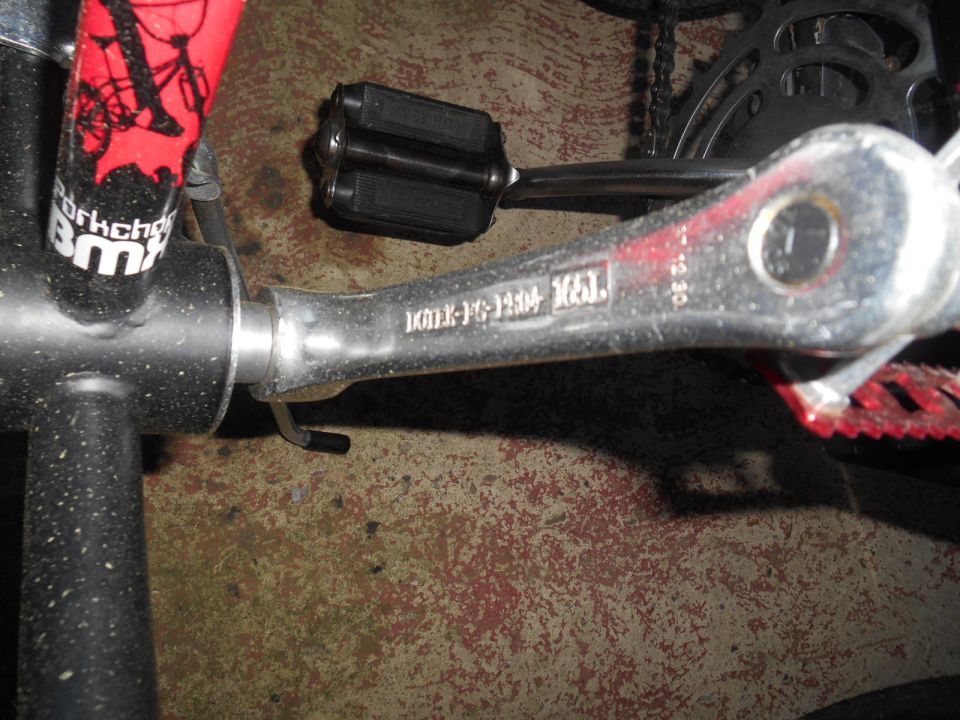 BMX bicycle frame with 'Parkchaser BMX' decal, crank arm with part number, and black pedal