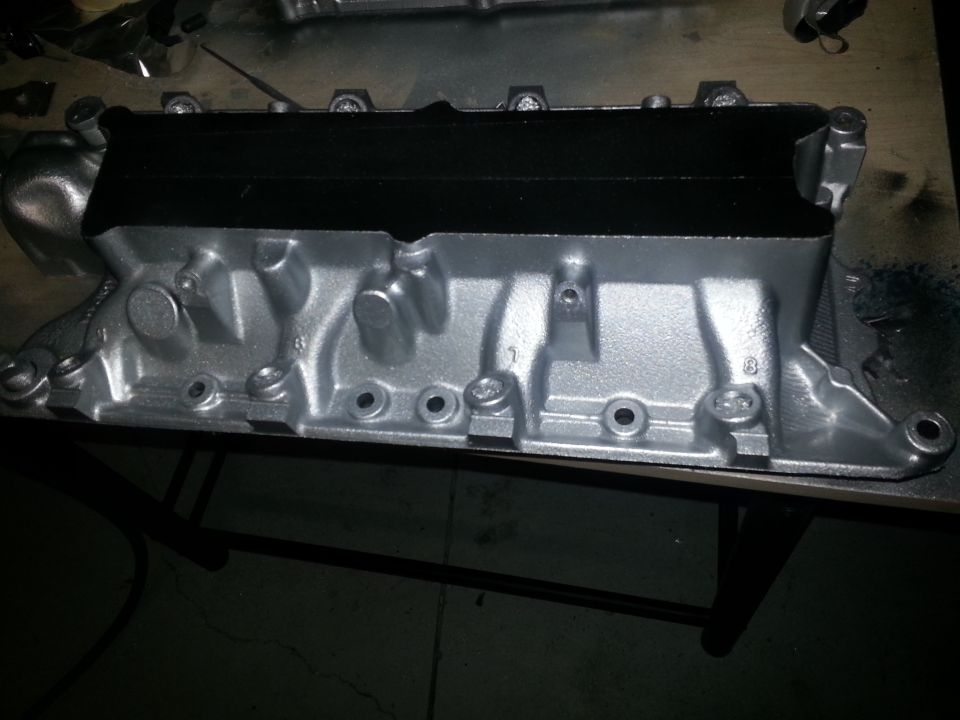 Silver painted engine intake manifold with black top section