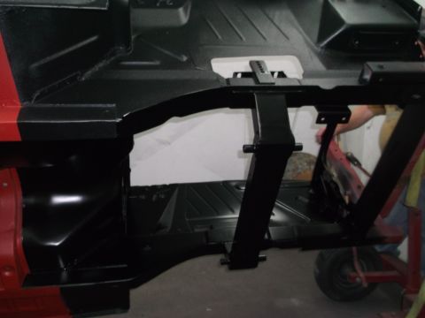1967 Ford Mustang - The undercarriage of a vehicle is shown with black paint and structural components.