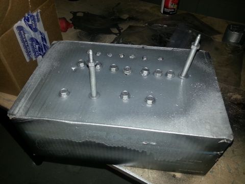 1994 Ford Bronco - A metal box with several bolts and studs attached to its surface.