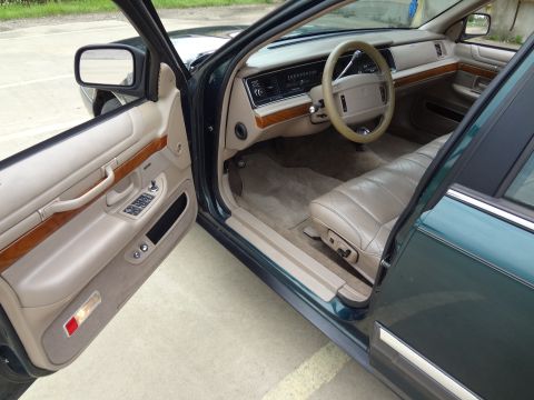 1993 Mercury Grand Marquis - Interior view of a 1993 Mercury Grand Marquis with tan leather seats and wood accents.